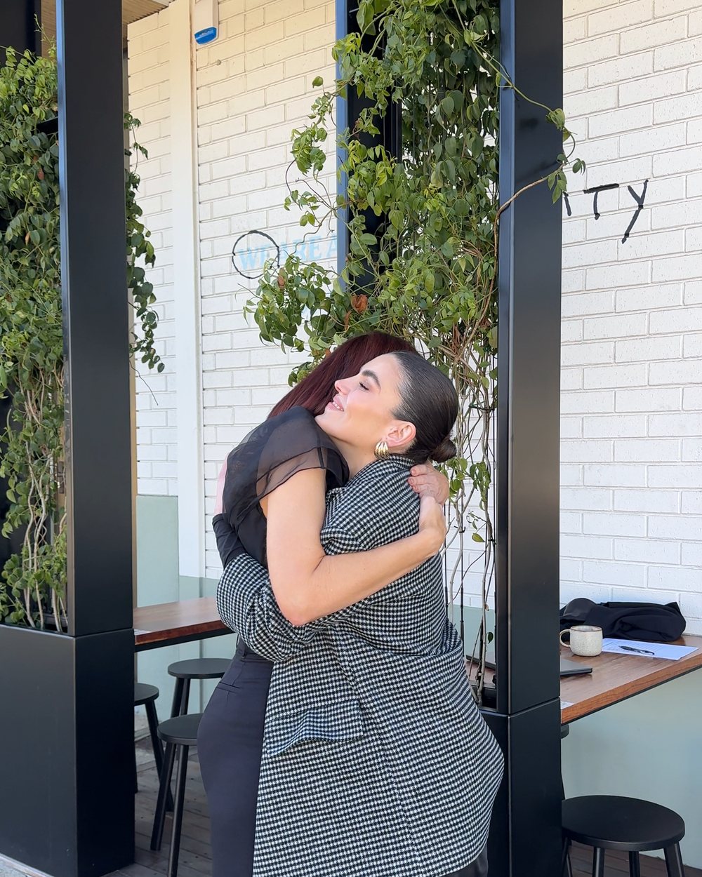 Renee and a stylist sharing a hug